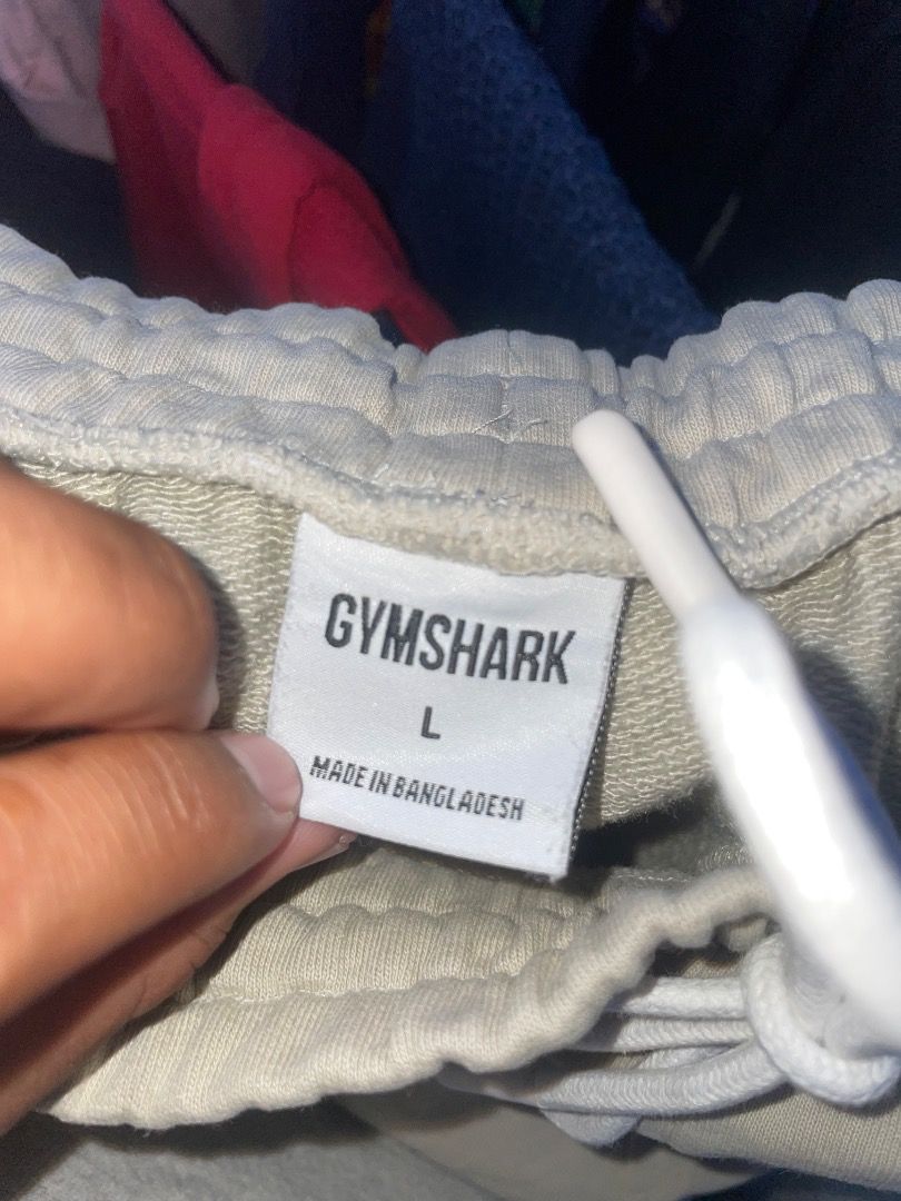 Gymshark Beige Sweatpants Size L (Category: Joggers) located in Puerto Princesa. Submitted by bestthrift123 (Listing ID 1465256029, Image 3). Description: - Brand: Gymshark - Color: Beige - Size: Large - Material: Soft fabric (Made in Bangladesh) - Design: Elastic waistband with white drawstring, white Gymshark logo on left thigh, and cuffed ankles - Fit/Usage: Comfortable fit, ideal for workouts or lounging.