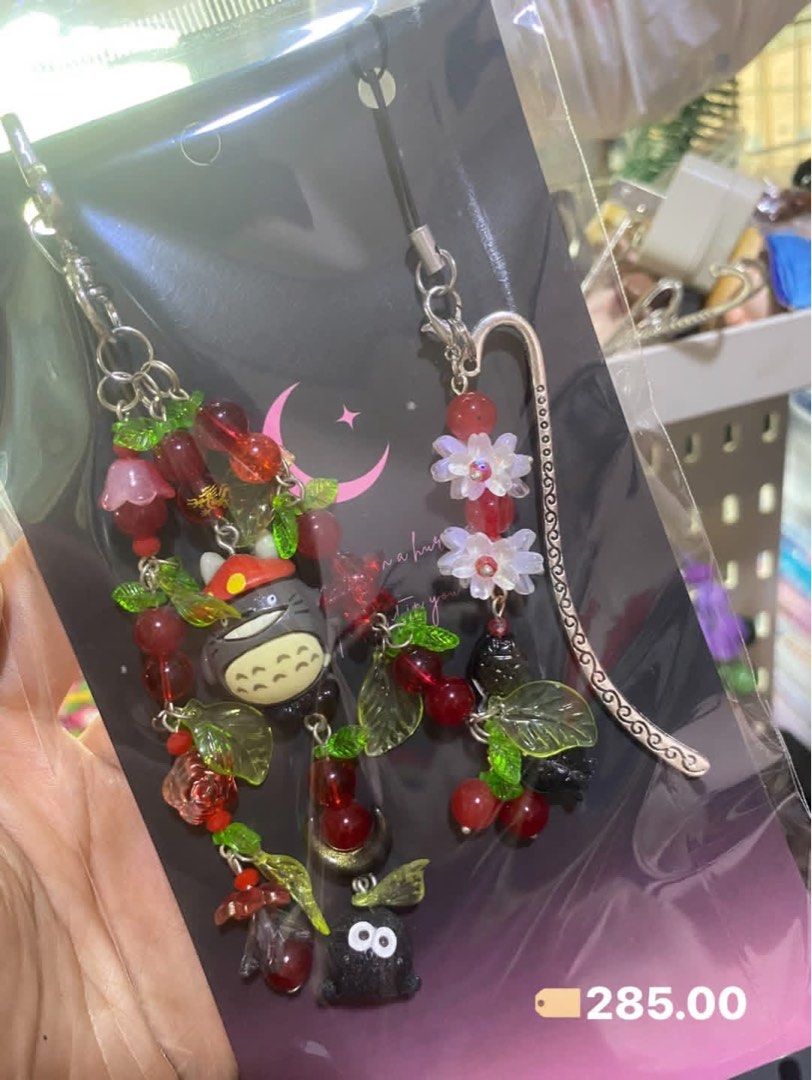 Handmade Totoro Beaded Keychain and Bookmark Set (Category: Charms) located in Tanauan. Submitted by mariacraftcorner (Listing ID 1465308985, Image 3). Description: - Handmade multi-colored beaded charms featuring adorable Totoro characters, soot sprites, cherries, flowers, and tiny drinks - Multi-functional: use as a bag charm, key chain, or attach the included metal bookmark hook for reading - Price: ₱285 each or ₱1,500 for the complete set.