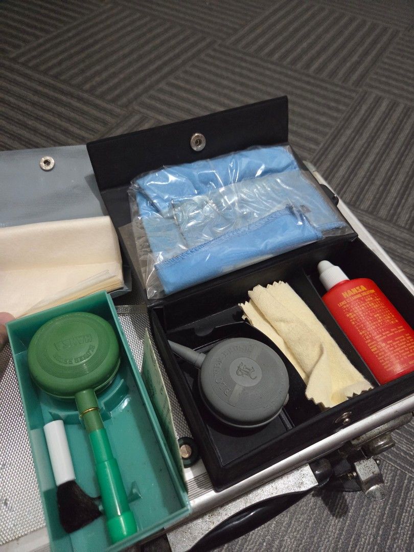 Hansa Camera Cleaning Set L with Solution and Brushes (Category: Cameras) located in Manila. Submitted by manilafilmshop (Listing ID 1465183459, Image 1). Description: - Complete Hansa vintage camera cleaning kit - Includes cleaning solution, lens cloths, air blowers, and brush tools - Comes in a stylish black storage case with gold lettering - Bonus: Extra green blower brush in its original clear plastic packaging - Ideal for maintaining vintage