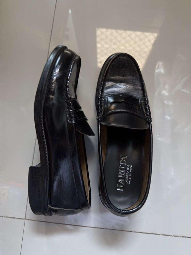 HARUTA ARVIN (Category: Dress Shoes) located in Cabanatuan. Submitted by archive.stuffz (Listing ID 1465243844, Image 2). Description: - Style: Black leather penny loafers / slip-on dress shoes - Details: Traditional moc-toe stitching, structured heel, flat sole, and standard instep strap - Versatility: Ideal staple footwear for formal wear or smart casual outfits - Condition: Worn a few times, with minor crease marks near the toe box -AS IS NO B