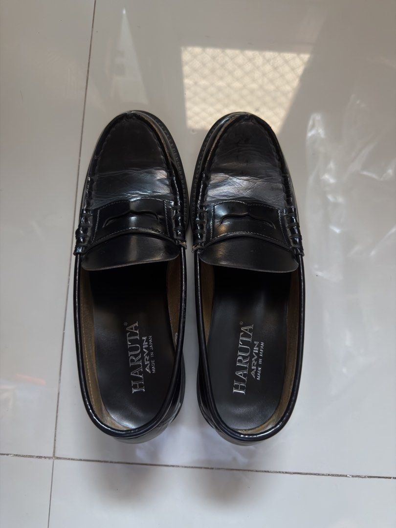 HARUTA ARVIN (Category: Dress Shoes) located in Cabanatuan. Submitted by archive.stuffz (Listing ID 1465243844, Image 3). Description: - Style: Black leather penny loafers / slip-on dress shoes - Details: Traditional moc-toe stitching, structured heel, flat sole, and standard instep strap - Versatility: Ideal staple footwear for formal wear or smart casual outfits - Condition: Worn a few times, with minor crease marks near the toe box -AS IS NO B