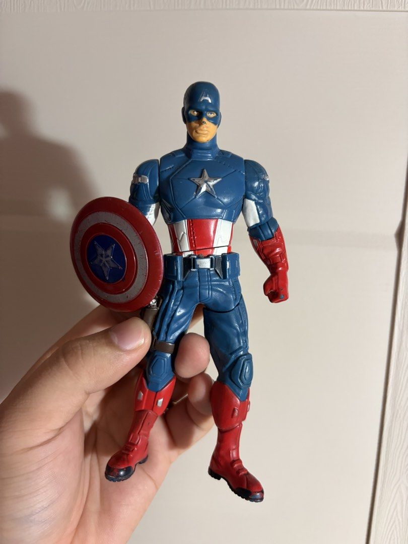 Hasbro Captain America Action Figure with Shield (Category: Figurines & Statues) located in Plaridel. Submitted by moddedjarvis (Listing ID 1465170945, Image 1). Description: - Brand: Hasbro (Made in China, Code: 20301) -Gimmick is working - Design: Classic red, white, and blue suit with visible back screw holes - Accessories: Includes the iconic round red and blue shield - Condition: Stands on its own; has minor paint wear on the boots and shiel