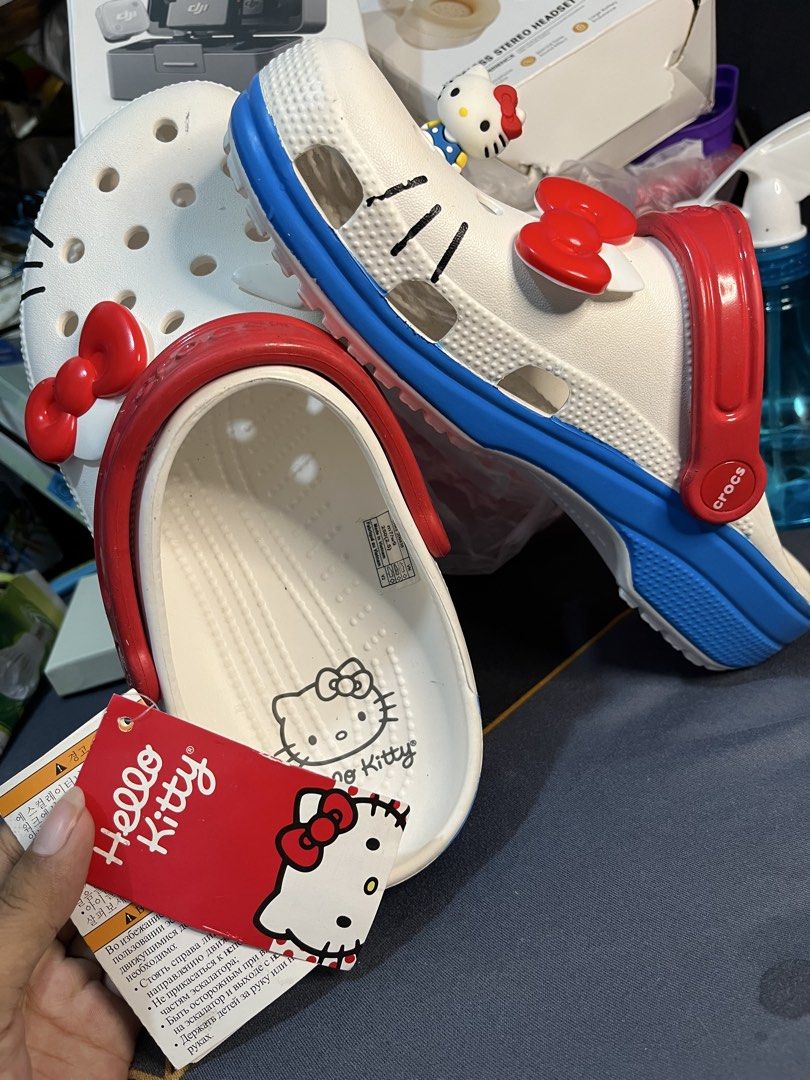 Hello Kitty Crocs Clogs White Red Blue Size M7 W9 (Category: Slippers and slides) located in Manila. Submitted by abbigail029. (Listing ID 1465201654, Image 2). Description: - Brand new with tags, never worn - Color: White with red strap and blue sole - Size: Men's 7 / Women's 9 - Features adorable red bow Jibbitz charms and Kitty side figure - Cute Kitty graphic printed inside the footbed - Perfect for Sanrio fans and daily wear.