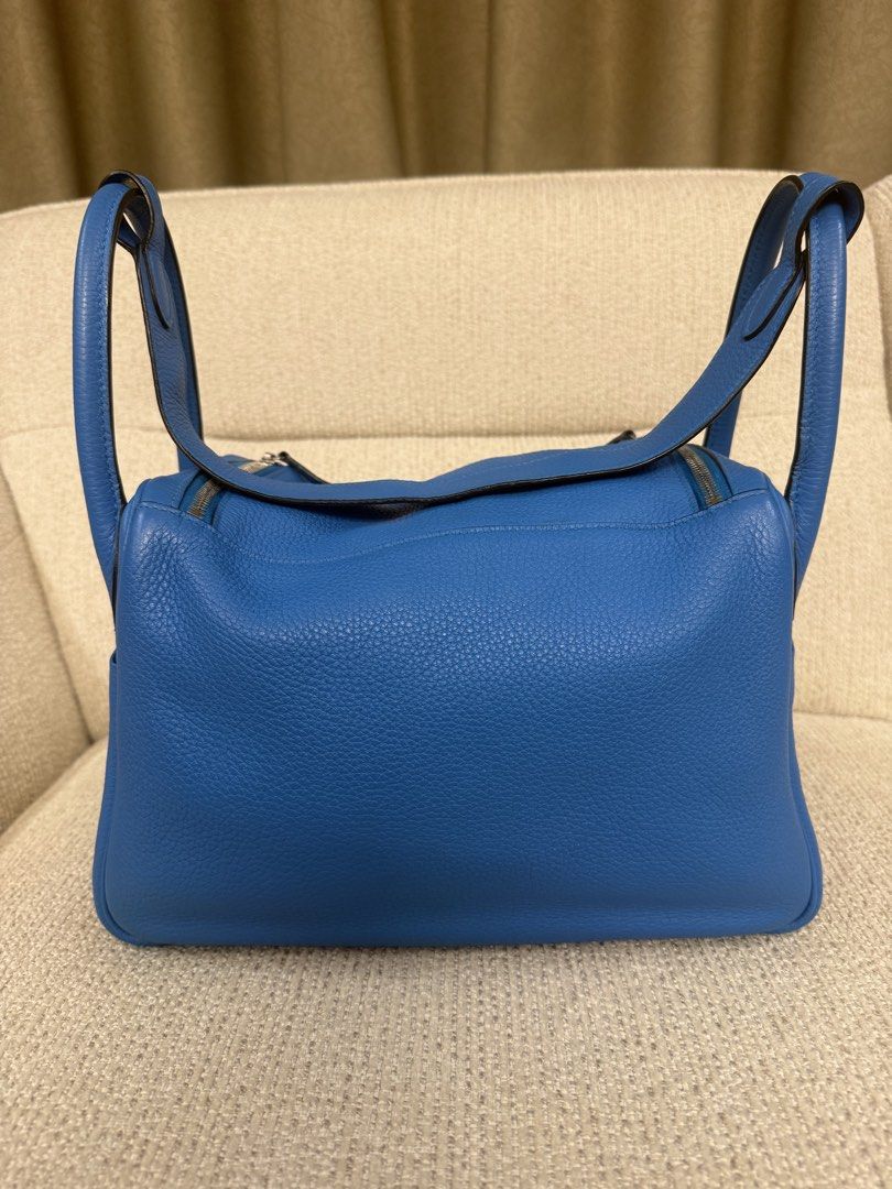 Hermes Lindy 30 bicolor (Category: Luxury Bags & Wallets) located in Makati City. Submitted by dgcurated09 (Listing ID 1465254412, Image 3). Description: - Brand: Hermès Lindy - Color: Vibrant blue - Material: Premium pebble-grained leather - Hardware: Silver-tone with classic turn-lock closure - Features: Dual handles, exterior side slip pockets, protective metal feet on the base - Condition: Well-maintained, clean stitching throughout - Inclusi