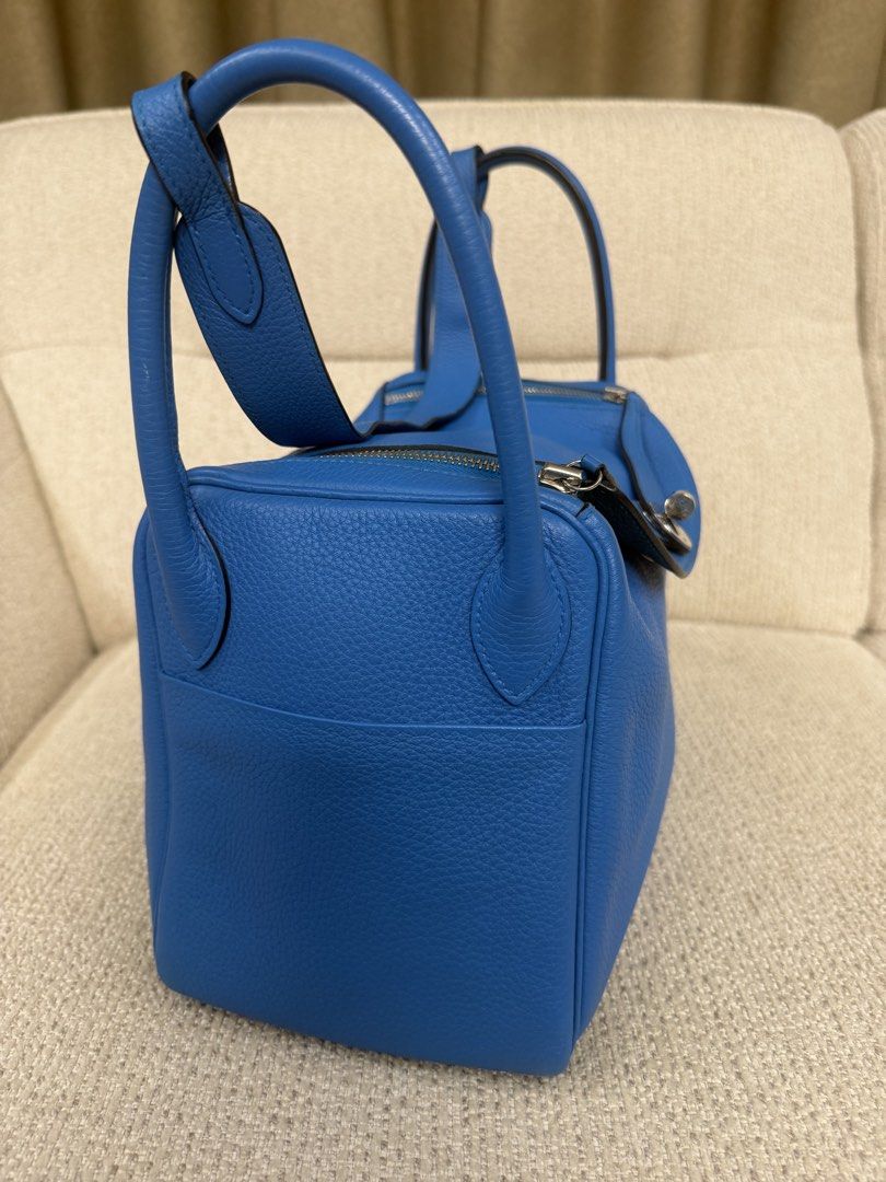 Hermes Lindy 30 bicolor (Category: Luxury Bags & Wallets) located in Makati City. Submitted by dgcurated09 (Listing ID 1465254412, Image 2). Description: - Brand: Hermès Lindy - Color: Vibrant blue - Material: Premium pebble-grained leather - Hardware: Silver-tone with classic turn-lock closure - Features: Dual handles, exterior side slip pockets, protective metal feet on the base - Condition: Well-maintained, clean stitching throughout - Inclusi