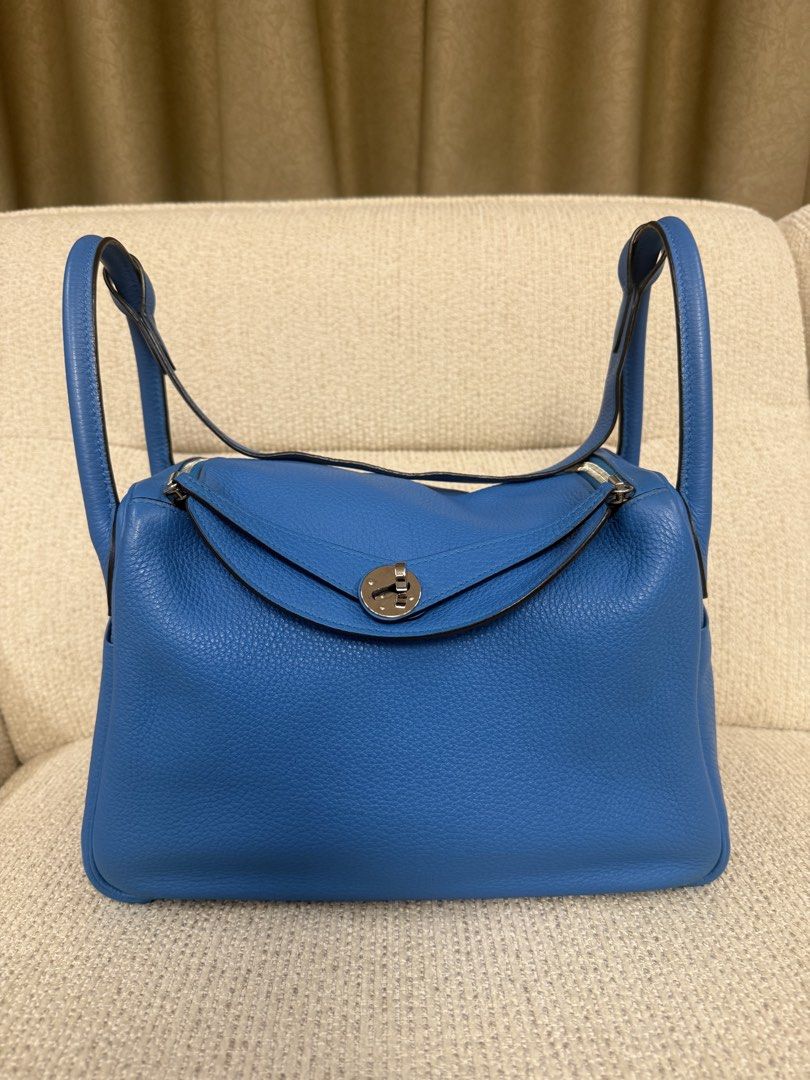 Hermes Lindy 30 bicolor (Category: Luxury Bags & Wallets) located in Makati City. Submitted by dgcurated09 (Listing ID 1465254412, Image 1). Description: - Brand: Hermès Lindy - Color: Vibrant blue - Material: Premium pebble-grained leather - Hardware: Silver-tone with classic turn-lock closure - Features: Dual handles, exterior side slip pockets, protective metal feet on the base - Condition: Well-maintained, clean stitching throughout - Inclusi