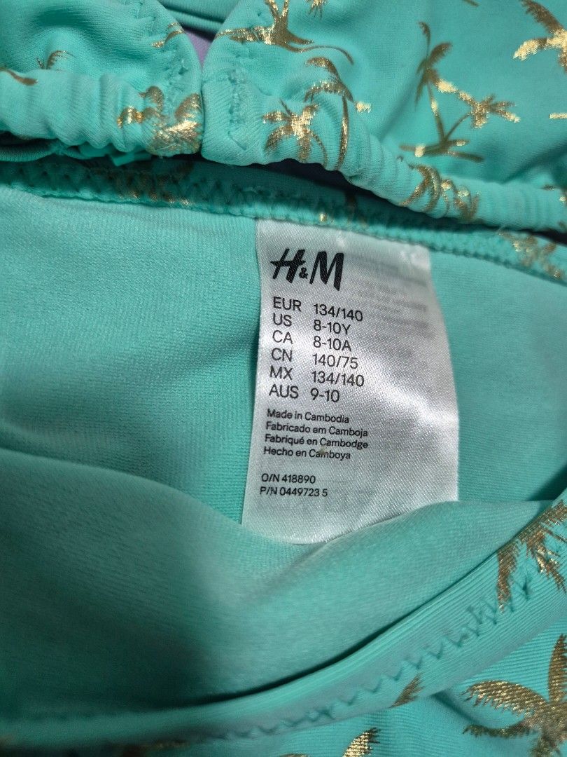 Swimsuit 2 piece H&M Size 8-10Y (Category: Babies & Kids Fashion) located in Manila. Submitted by sorayabarr50152 (Listing ID 1465320696, Image 3). Description: - Brand: H&M - Style: Teal bikini top with all-over gold palm tree print - Features: Adjustable straps and gathered fabric detail at the front - Size: EUR 134/140, US 8-10Y, CA 8-10A - Origin: Made in Cambodia - Product Codes: O/N 418890, P/N 0449723 5.