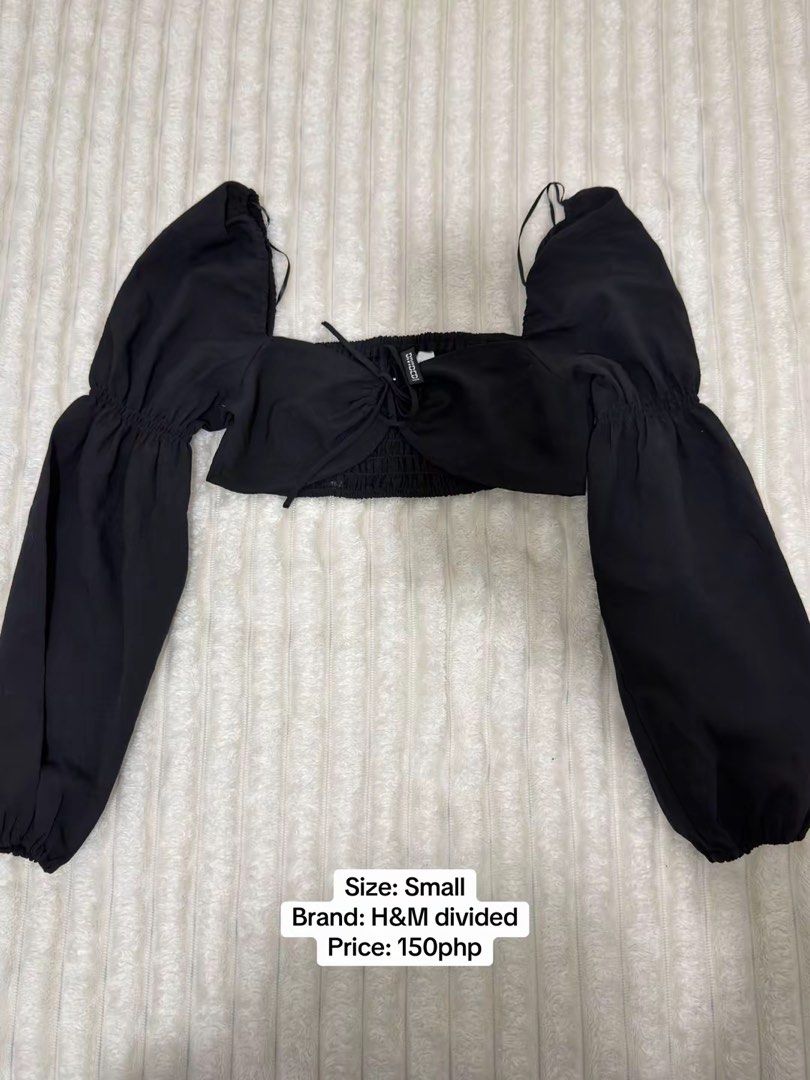 H&M divided black crop top size S (Category: Shirts) located in Pasig City. Submitted by jamie.sebuc (Listing ID 1465237730, Image 1). Description: - Brand: H&M Divided - Size: Small (S) - Color: Classic Black - Style: Crop top with square neckline and front tie detail - Sleeves: Long puff sleeves with comfortable elastic cuffs - Back: Smocked back panel for a better fit - Fabric: Lightweight and comfortable - Perfect to pair with high-waist jean