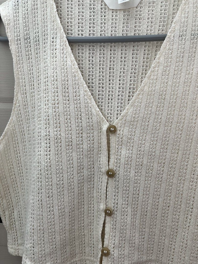 H&M Knit Cropped Vest (Category: Sleeveless) located in Caloocan City. Submitted by yukiipatootie_ (Listing ID 1465207258, Image 2). Description: - Brand: H&M - Size: EUR L on tag - Fit for small and medium fram - DM FOR WHEN WORN - Color: Cream - Style: V-neck sleeveless knit vest with front tortoiseshell buttons - Texture: Chunky textured weave pattern - Condition: Great for layering or wearing on its own.