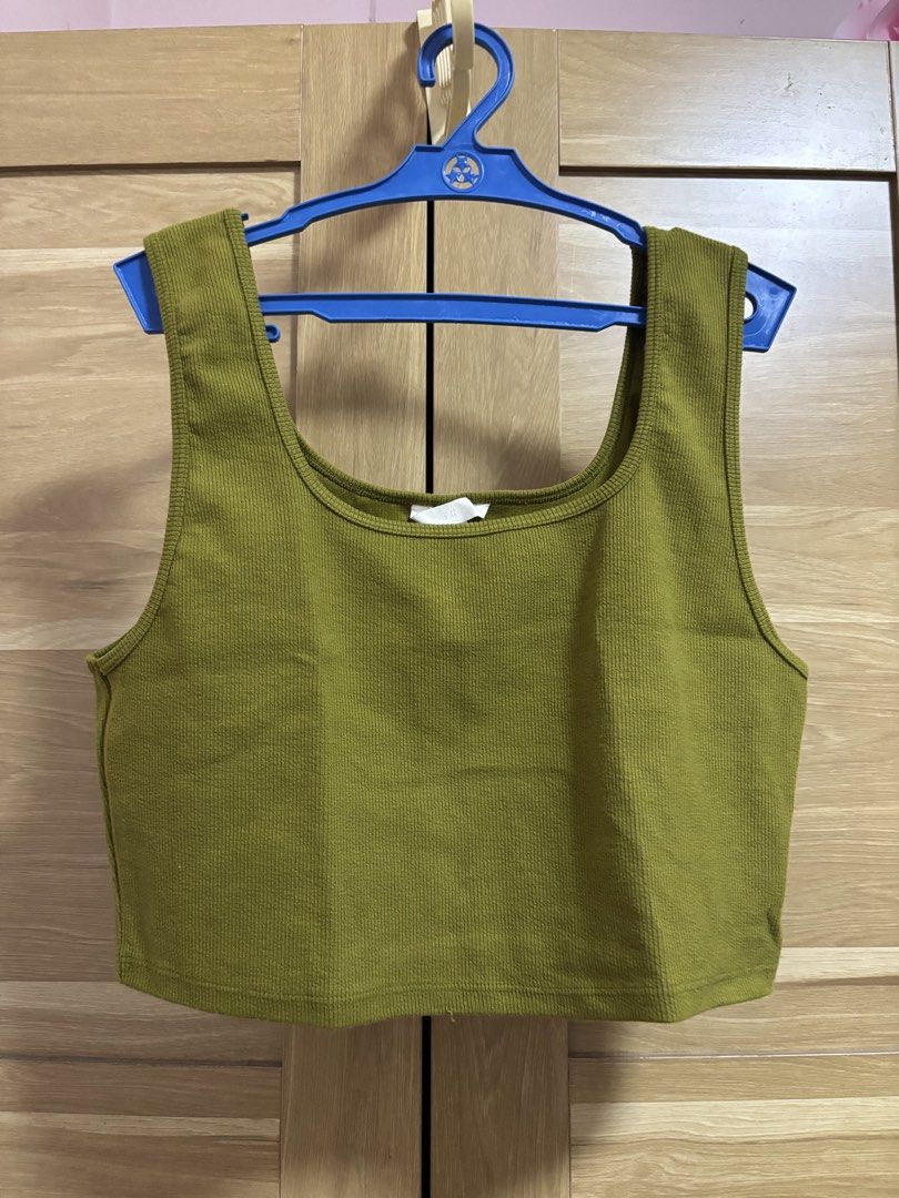 H&M Olive Green Ribbed Crop Top Size L (Category: Sleeveless) located in Cebu City. Submitted by teveschels38656 (Listing ID 1465335586, Image 1). Description: - Brand: H&M - Color: Olive Green - Size: L - Material: Stretchy ribbed fabric - Design: Square neckline with thick shoulder straps - Style: Casual basic, great to match with high-waisted jeans or skirts WORN ONCE.