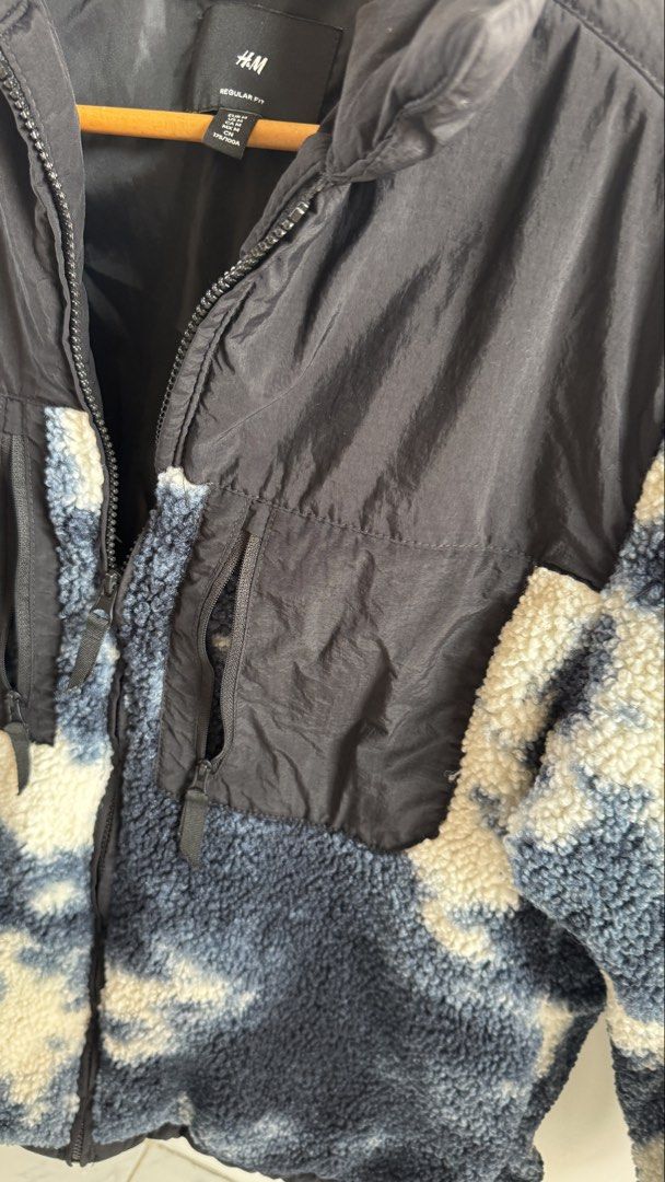 H&M Regular Fit Fleece Jacket Size M (Category: Coats, Jackets and Outerwear) located in Quezon City. Submitted by meezck (Listing ID 1465188394, Image 3). Description: - Brand/Model: H&M Regular Fit Jacket - Size: M (175/100A) - Design: Black nylon upper with a blue and white tie-dye textured fleece body - Features: Full front zipper, high collar, and two zipped chest pockets - Material: Polyamide shell and polyester fleece/lining - Care: Machin
