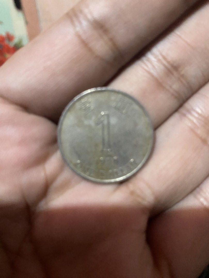 Hong Kong One Dollar Coin 1990 (Category: Currency) located in Paranaque City. Submitted by galahad0707 (Listing ID 1465338934, Image 2). Description: - Item: Vintage Hong Kong One Dollar Coin - Year: 1980 - Condition: Normal circulation wear with natural tarnishing - Details: Clear numerical '1' denomination and distinct lettering - Ideal for: Numismatists and coin enthusiasts - Shipping: Fast ship-out available.
