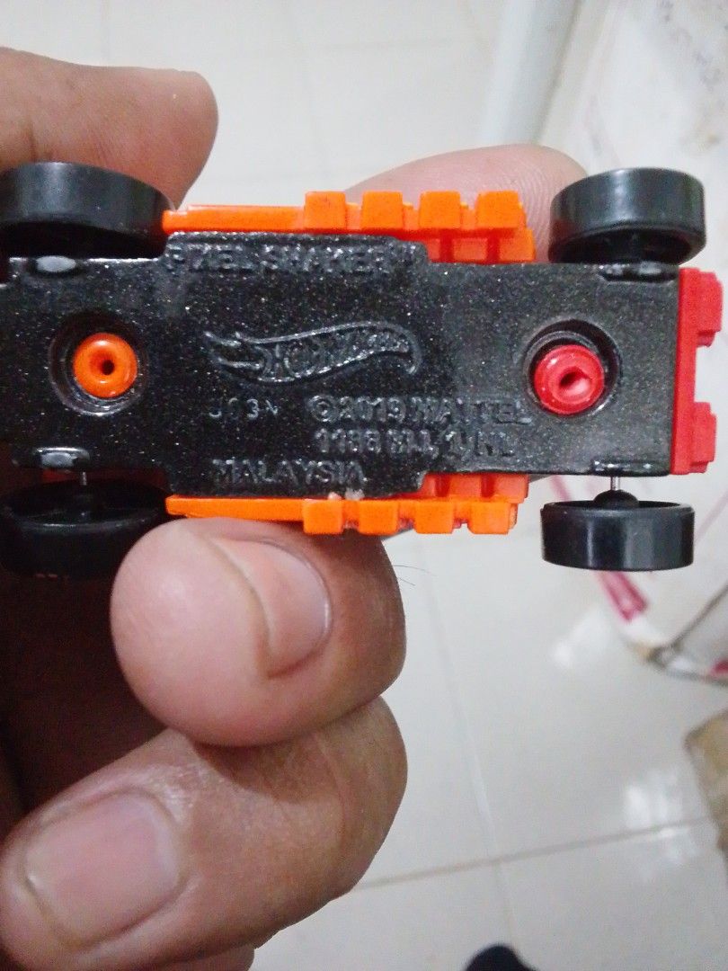 Hot Wheels Pixel Shaker Orange Toy Car (Category: Vehicle & Diecast Models) located in Quezon City. Submitted by zealstone_baf57c (Listing ID 1465244947, Image 3). Description: - Model: Hot Wheels Pixel Shaker - Color: Bright orange with pixel-style brick design - Details: Red front engine and black wheels - Era: 2019 Mattel stamp on black base - Origin: Made in Malaysia - Condition: Compact toy vehicle with solid rolling wheels.