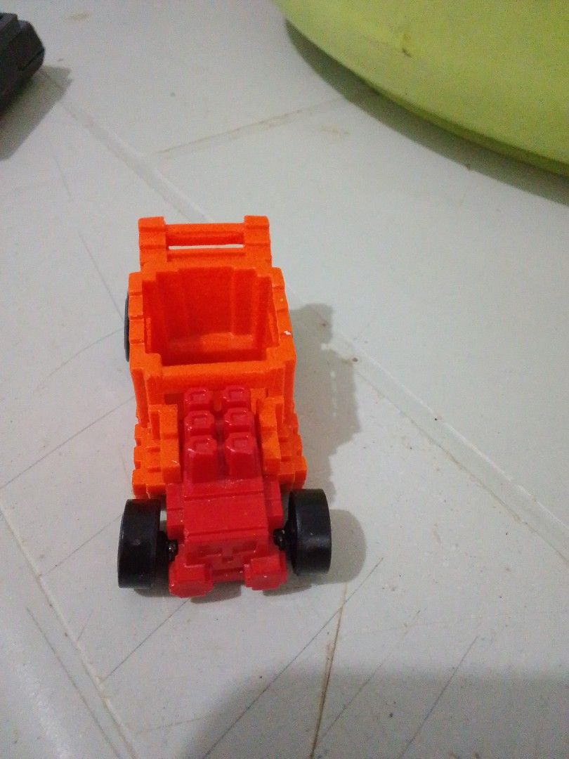 Hot Wheels Pixel Shaker Orange Toy Car (Category: Vehicle & Diecast Models) located in Quezon City. Submitted by zealstone_baf57c (Listing ID 1465244947, Image 2). Description: - Model: Hot Wheels Pixel Shaker - Color: Bright orange with pixel-style brick design - Details: Red front engine and black wheels - Era: 2019 Mattel stamp on black base - Origin: Made in Malaysia - Condition: Compact toy vehicle with solid rolling wheels.