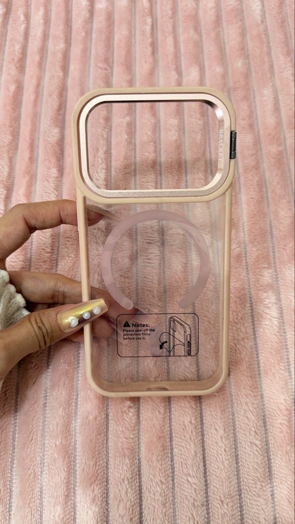 IPHONE 17pro CASE (Category: Cases & Sleeves) located in Cavite. Submitted by jam90053 (Listing ID 1465379557, Image 1). Description: - Compatible Model: iPhone 17 Pro - Color: Elegant Pink - Features: Built-in camera bracket/stand, transparent clear back, protective design - Condition: Brand new in original packaging - Meetup available: Puregold or Jollibee Tanza / Naic area.