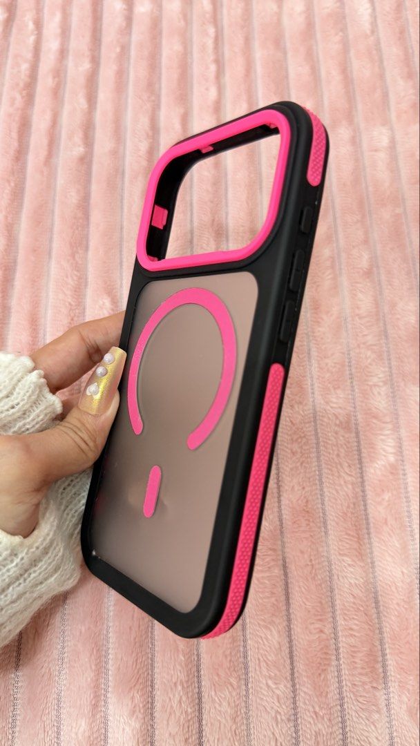 IPHONE 17pro case (Category: Cases & Sleeves) located in Cavite. Submitted by jam90053 (Listing ID 1465379643, Image 3). Description: - Compatible Model: iPhone 17 Pro - Color: Black frame with vibrant pink accents and frosted back - Features: Magnetic charging ring design, shock-absorbing bumper edges - Condition: Brand new, well-packaged - Shipping: Nationwide mailing available.