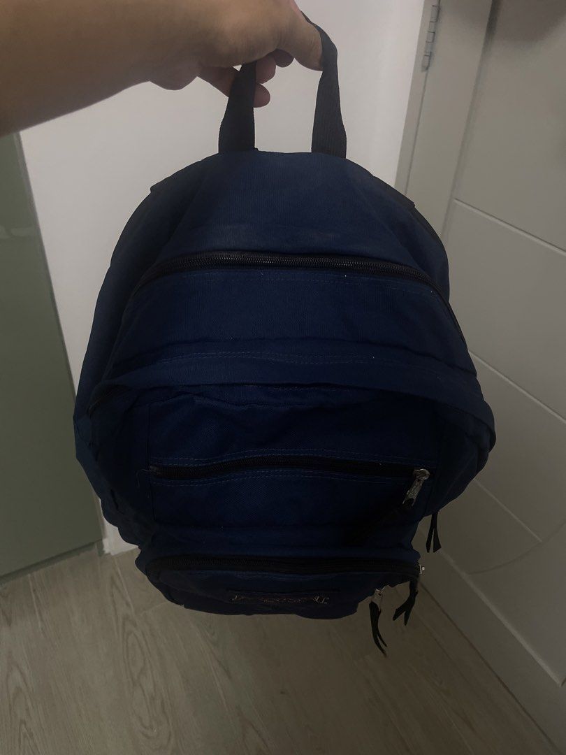 JanSport Navy Blue Backpack with Multiple Compartments (Category: Backpacks) located in Angeles City. Submitted by lukemafinds (Listing ID 1465341847, Image 2). Description: - Authentic JanSport navy blue backpack - Multiple front zippered compartments for easy organization - Convenient mesh side pocket for water bottles - Durable top handle and comfortable adjustable shoulder straps - Classic design with spacious storage, ideal for school, work,