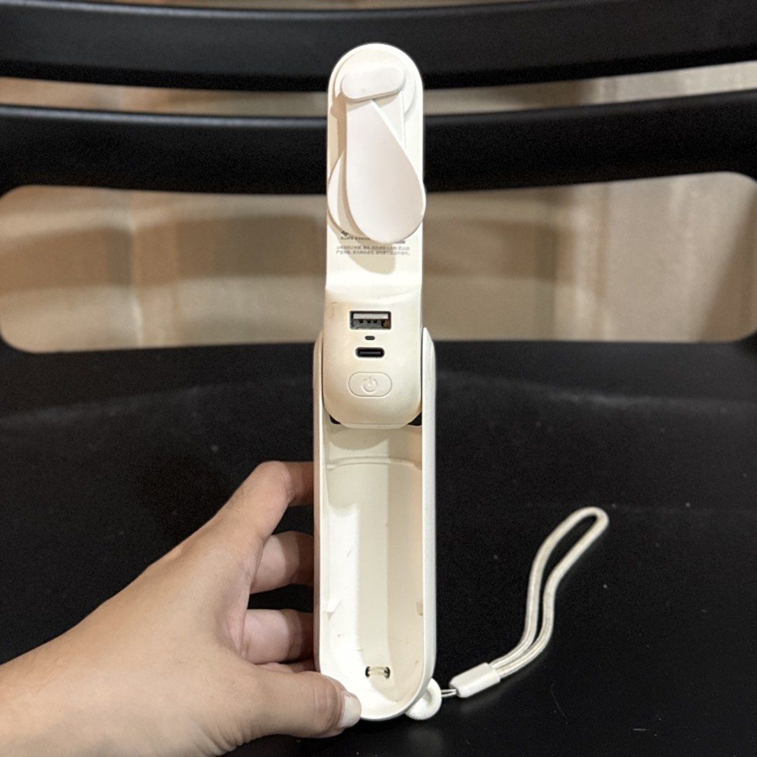JISULIFE handheld mini fan with power bank function (Category: Fans) located in Makati City. Submitted by julyco. (Listing ID 1465362094, Image 2). Description: - Brand New JISULIFE Portable Mini Fan (White) - Compact and foldable design, perfect for travel and daily commutes - Doubles as a power bank with USB and Type-C charging ports - Built-in lanyard for convenient and easy carrying - Rechargeable battery with adjustable multiple speed settin