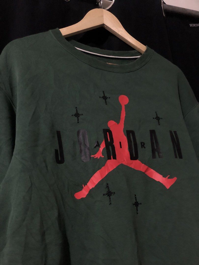 Jordan Green JUMPMAN Sweatshirt Medium (Category: Coats, Jackets and Outerwear) located in Quezon City. Submitted by yeahsource222 (Listing ID 1465207641, Image 3). Description: - Brand: Jordan - Color: Green with red and black details - Size: Medium (M) - Material: Comfortable cotton fleece - Design: Classic Jumpman logo and star graphics on the front, ribbed cuffs and hem - Authenticity: Interior neck tag with 'Est. 1985' and style code DO9153-