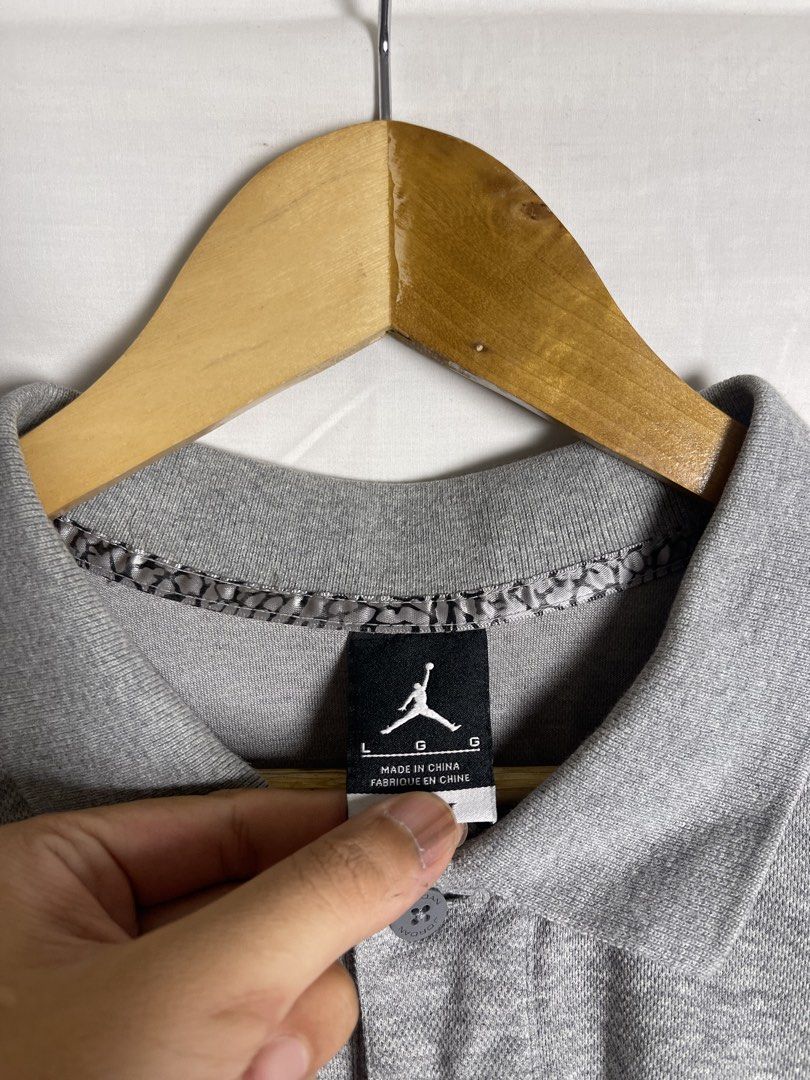 Jordan Grey Polo Shirt Size L (Category: Tshirts & Polo Shirts ) located in Manila. Submitted by noahcastilljos363 (Listing ID 1465380237, Image 2). Description: - Brand: Jordan - Color: Grey - Size: L - Material: 65% Cotton, 35% Polyester (Made in China) - Design: Classic collar with 2 buttons and short sleeves - Details: Black embroidered Jumpman logo on left chest, unique elephant print lining inside the collar, and side hem slits - Condition: