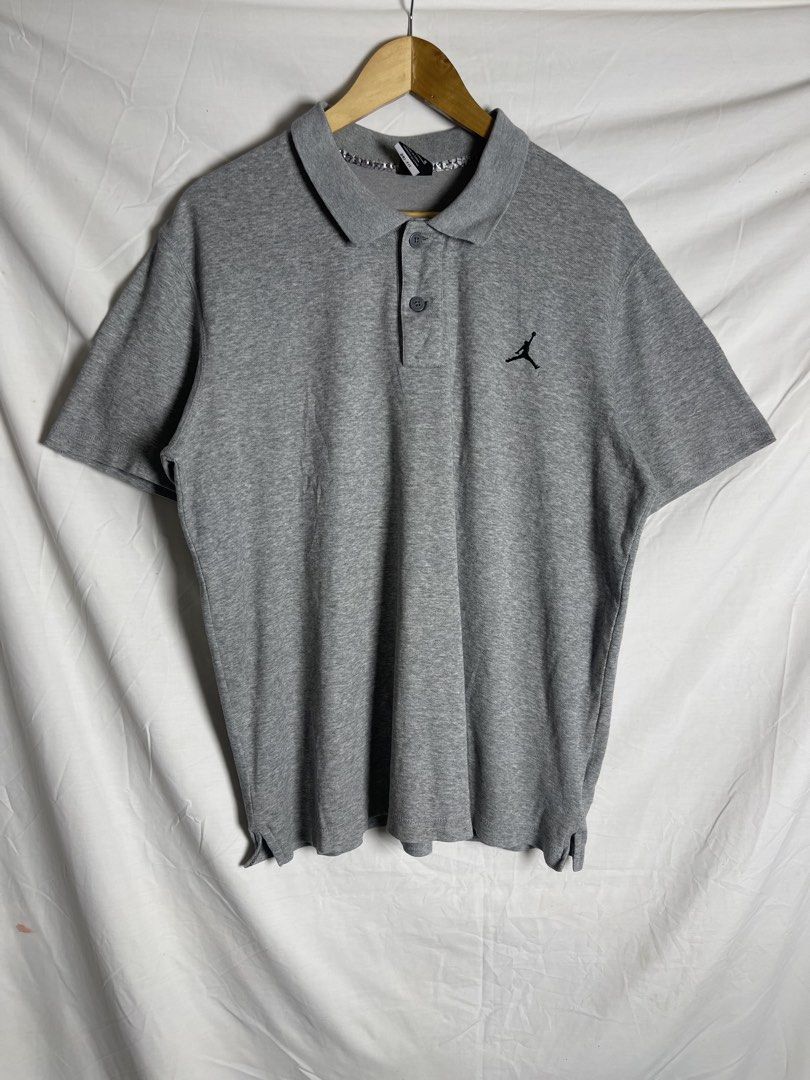 Jordan Grey Polo Shirt Size L (Category: Tshirts & Polo Shirts ) located in Manila. Submitted by noahcastilljos363 (Listing ID 1465380237, Image 1). Description: - Brand: Jordan - Color: Grey - Size: L - Material: 65% Cotton, 35% Polyester (Made in China) - Design: Classic collar with 2 buttons and short sleeves - Details: Black embroidered Jumpman logo on left chest, unique elephant print lining inside the collar, and side hem slits - Condition: