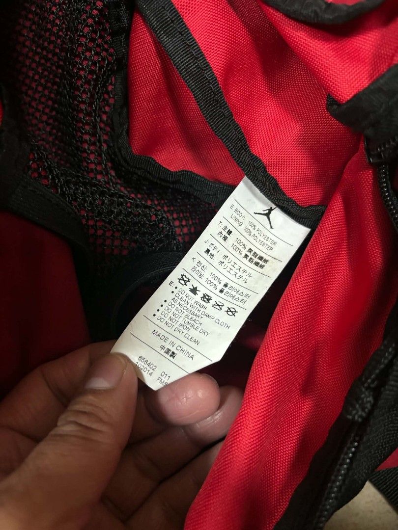 Jordan Red and Black Duffel Bag (Category: Sling Bags) located in Caloocan City. Submitted by joshuadyogi0122 (Listing ID 1465181737, Image 2). Description: - Authentic Jordan duffel bag in a classic red and black colorway - Iconic Jumpman logo printed prominently on the front - Spacious main compartment with 100% polyester lining - Convenient zippered front pocket for quick-access items - Dual carrying handles equipped with a padded grip for ext