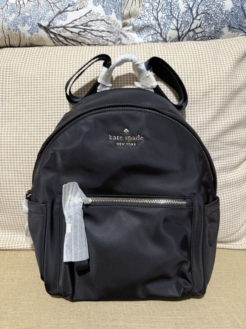 Kate Spade Chelsea Medium Backpack Black (Category: Backpacks) located in Quezon City. Submitted by gel.cortez (Listing ID 1465217446, Image 1). Description: - Brand: Kate Spade - Model: Chelsea Medium Backpack - Color: Classic Black - Material: Durable nylon with signature lining - Features: Secure zipper closure, handy front pocket, and multiple interior pockets for organization - Comfort: Adjustable shoulder straps and top handle - Condition: 