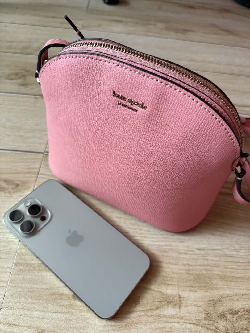 Kate Spade Dome Crossbody Bag Pink (Category: Cross-body Bags) located in San Pedro. Submitted by silverlion-4d46 (Listing ID 1465210653, Image 3). Description: - Brand: Kate Spade New York - Color: Bright Pink - Material: Structured leather with gold foil logo - Closure: Secure top zipper - Strap: Long, adjustable crossbody strap - Capacity: Everyday size fits phone, keys, and wallet - Condition: 100% authentic and well-maintained.