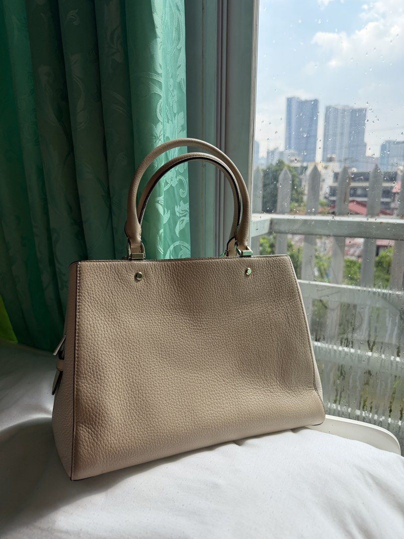 Kate Spade Leila Medium Triple Compartment Satchel (Category: Tote Bags) located in Manila. Submitted by jsscakim (Listing ID 1465219351, Image 2). Description: - Brand: Kate Spade New York - Material: Premium beige pebbled leather - Hardware: Gold-tone with protective metal feet at the base - Structure: Structured tote with double top handles - Strap: Includes adjustable and detachable leather shoulder strap - Organization: Secure zip compartmen
