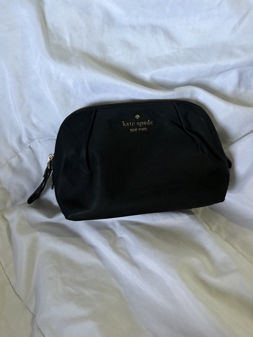 Kate Spade Pouch (Category: Purses & Pouches) located in Batangas. Submitted by gaprelovedthings (Listing ID 1465276816, Image 1). Description: - Authentic - Brand: Kate Spade New York - Material: Durable black nylon with gold-toned hardware - Design: Elegant pleated detailing on front and back, secure zipper closure with fabric pull tab - Interior: Clean lining with ample space for makeup and daily essentials - Condition: Well-maintained with mi