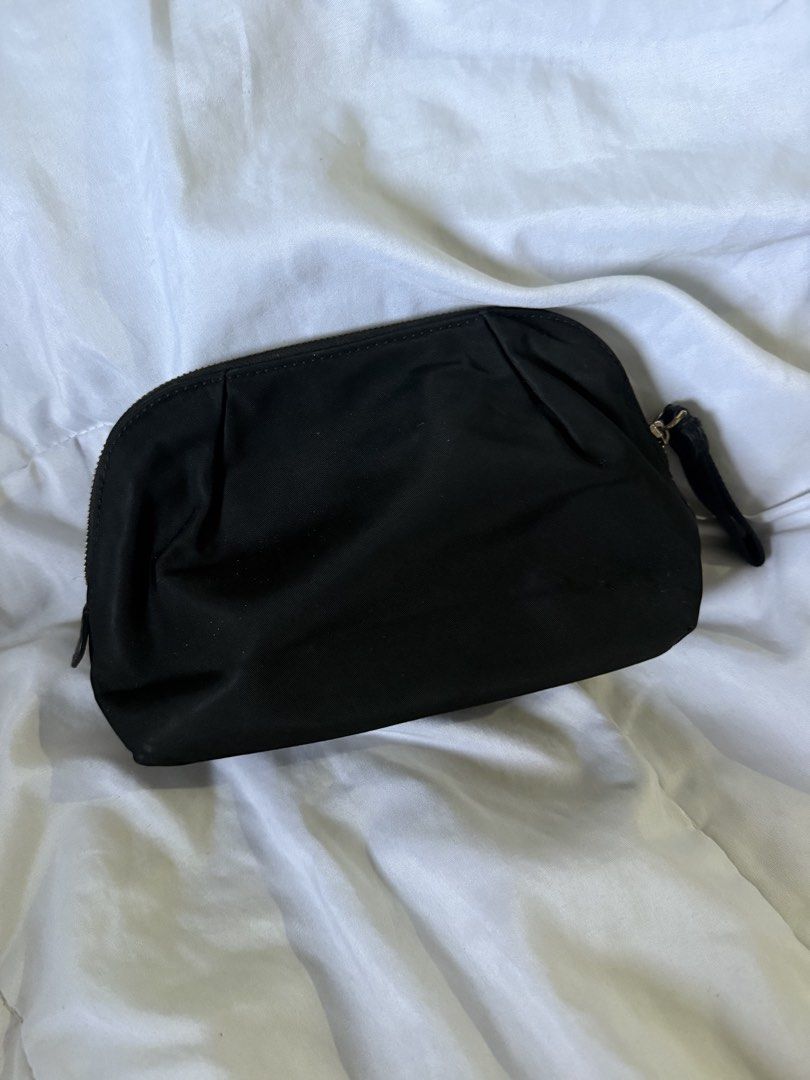 Kate Spade Pouch (Category: Purses & Pouches) located in Batangas. Submitted by gaprelovedthings (Listing ID 1465276816, Image 2). Description: - Authentic - Brand: Kate Spade New York - Material: Durable black nylon with gold-toned hardware - Design: Elegant pleated detailing on front and back, secure zipper closure with fabric pull tab - Interior: Clean lining with ample space for makeup and daily essentials - Condition: Well-maintained with mi