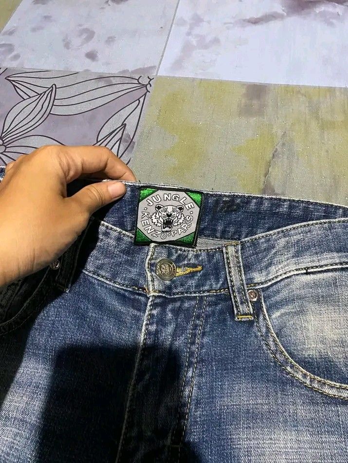 Kenzo Paris Jungle Distressed Denim Jeans (Category: Jeans) located in Manila. Submitted by bright.mayess (Listing ID 1465373563, Image 3). Description: - Brand: Kenzo Paris (Jungle line) - Style: Slim fit distressed denim jeans in blue wash - Design: Signature tiger patch on the back pocket with branded inner waistband tags - Material: 100% premium cotton - Condition: Excellent, unique statement piece.