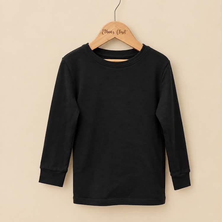 Kids Black Long Sleeve T-Shirt Basic Crewneck (Category: Babies & Kids Fashion) located in Manila. Submitted by joshbelgic17602 (Listing ID 1465210170, Image 1). Description: - Color: Solid black - Style: Crewneck long sleeve top with standard fit - Material: Soft and comfortable cotton - Details: Ribbed cuffs and hem for a snug feel - Condition: Washed, clean, and stored properly - Versatility: Perfect everyday basic for layering.