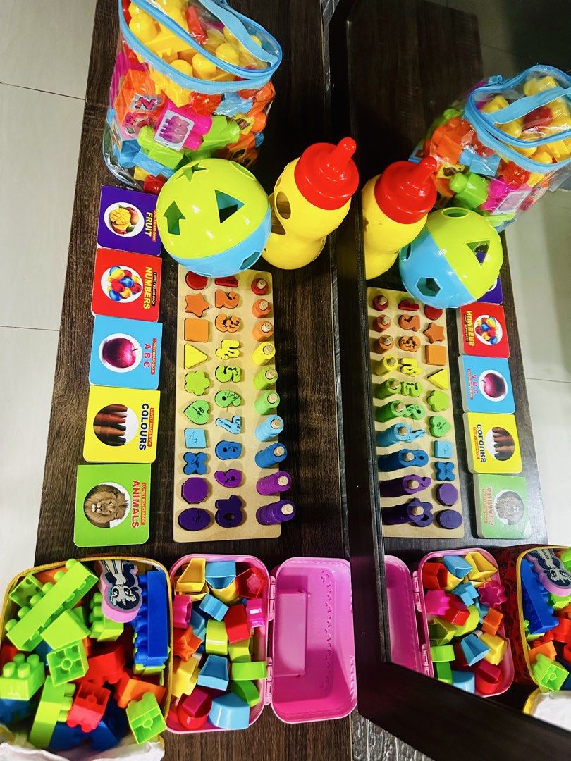 Kids Learning Toy Bundle Shape Sorter Wooden Pegs Blocks (Category: Educational & Learning Toys) located in Quezon City. Submitted by jam2020 (Listing ID 1465225352, Image 1). Description: - All-in-one toddler learning bundle - Wooden board with number counting pegs and shape matching - Soft plastic building blocks with 2 storage bags - Shape sorter ball and bottle toys - 5 colorful board books (fruits, numbers, ABC, colors, animals) - Great for 