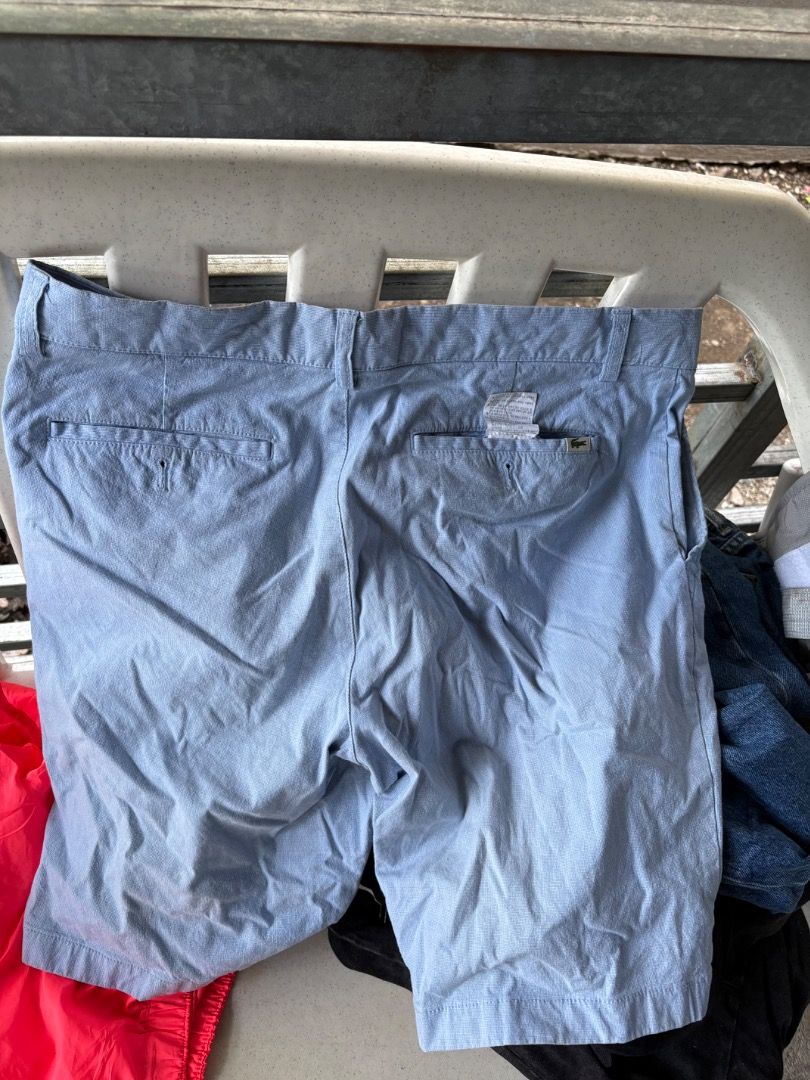Lacoste light blue casual shorts size 42 (Category: Shorts) located in Danao, Cebu. Submitted by kentoy25 (Listing ID 1465241928, Image 2). Description: - Brand: Lacoste - Color: Light Blue - Size: 42 (tag on back pocket) - Material: Cotton and polyurethane blend - Pockets: Two front pockets, two back welt pockets with button closure - Details: Small embroidered alligator logo on the right back pocket - Style: Casual, ideal for warm weather.