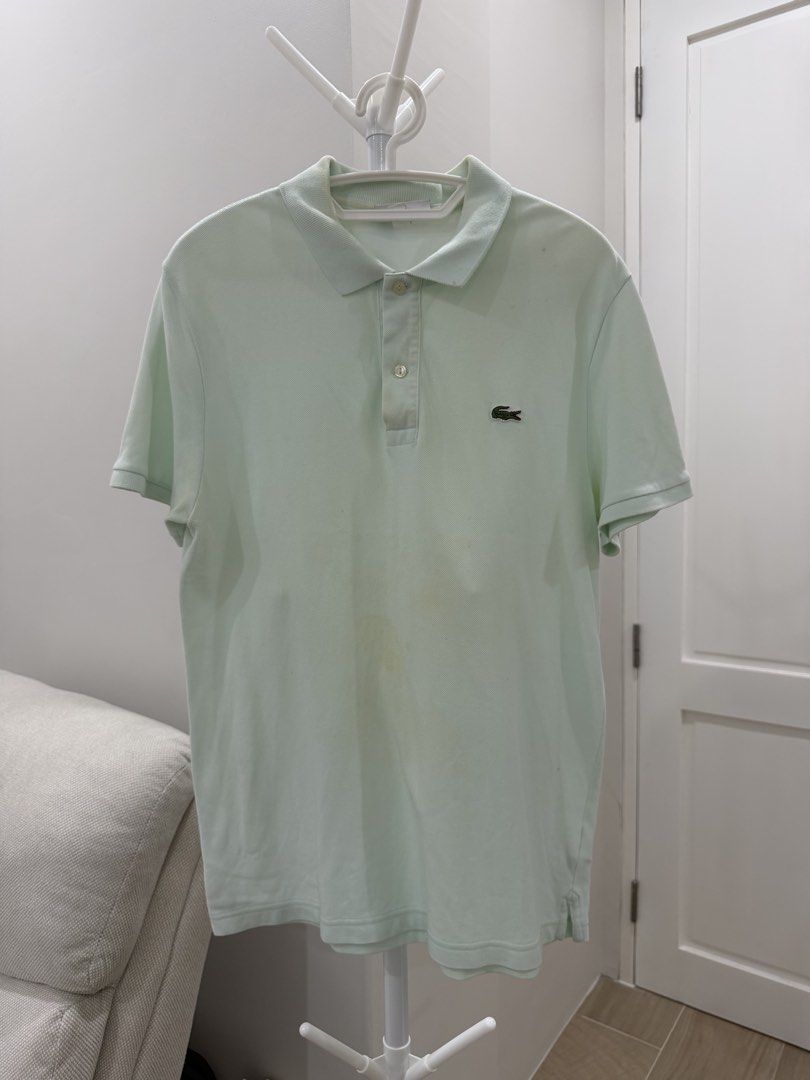 Lacoste Light Green Polo Shirt (Category: Tshirts & Polo Shirts ) located in Talisay. Submitted by itslucym (Listing ID 1465334301, Image 3). Description: - Brand: Lacoste - Color: Mint green - Material: Piqué cotton fabric - Features: Classic collar with two-button placket, standard short-sleeve fit, iconic embroidered crocodile logo on the left chest - Flaws: Noticeable yellowish stains on the lower front area and near the sleeve - Condition: P