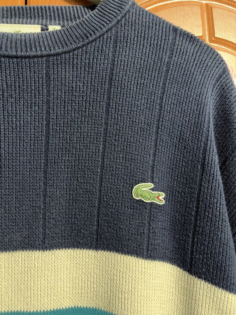 Lacoste Navy Blue Striped Knit Sweater Size 4 (Category: Longsleeves) located in Caloocan City. Submitted by puremountain.2e6573 (Listing ID 1465344308, Image 2). Description: Navy blue Lacoste knit sweater with thick white and bright blue chest stripes. Classic embroidered green crocodile logo on the left chest. Ribbed crew neck and vertical knit texture throughout. Size 4 tag at the collar. Clean interior tag stitching..