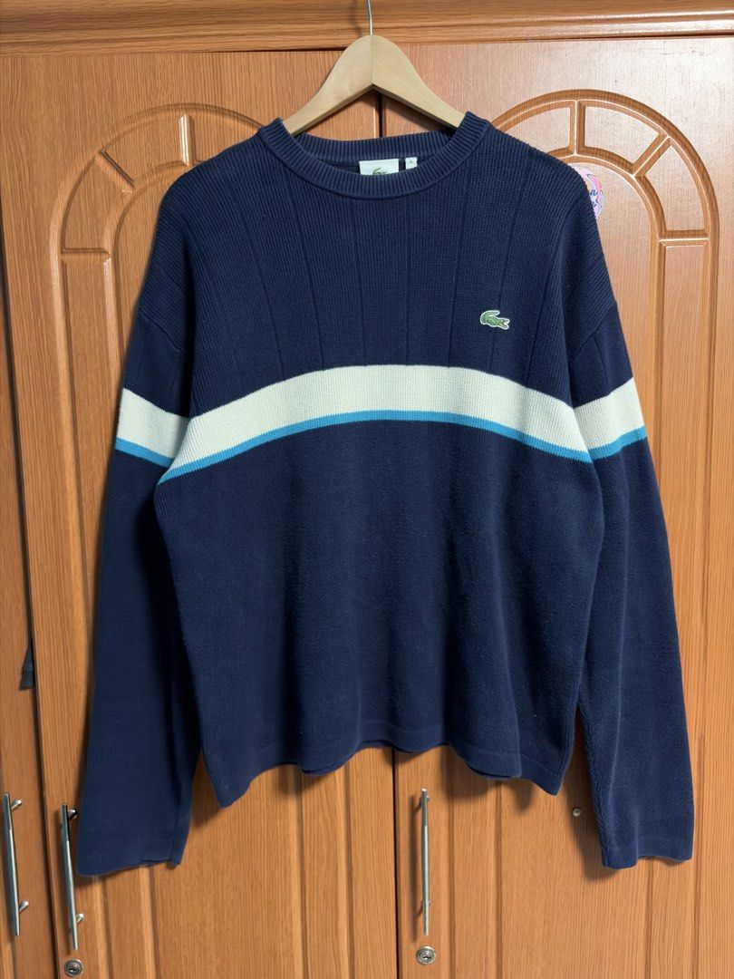 Lacoste Navy Blue Striped Knit Sweater Size 4 (Category: Longsleeves) located in Caloocan City. Submitted by puremountain.2e6573 (Listing ID 1465344308, Image 1). Description: Navy blue Lacoste knit sweater with thick white and bright blue chest stripes. Classic embroidered green crocodile logo on the left chest. Ribbed crew neck and vertical knit texture throughout. Size 4 tag at the collar. Clean interior tag stitching..