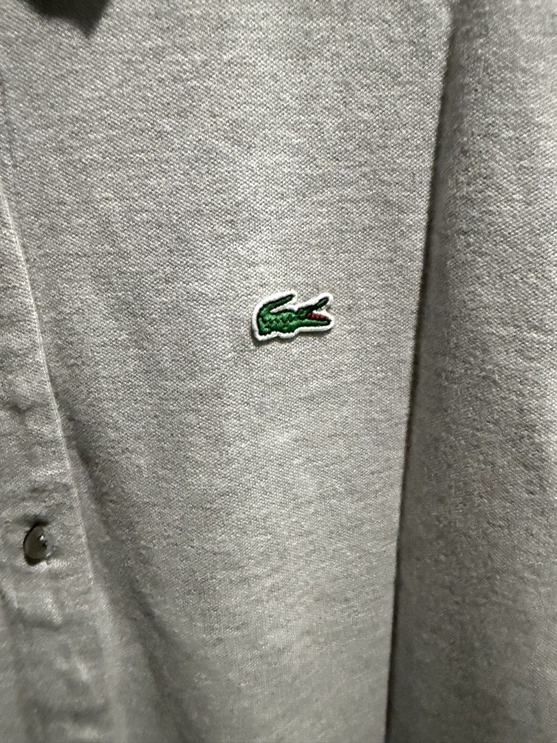 Lacoste Polo Dress (Category: Dresses) located in Mandaluyong City. Submitted by whitemoveout (Listing ID 1465325310, Image 2). Description: - Brand: Lacoste ORIGINAL - Style: Slim fit polo dress - Color: Grey - Size: 42 (Tag on collar) - Material: Soft cotton blend with interior care tags intact - Details: Full button placket with matching buttons, classic polo collar, and short sleeves - Branding: Iconic green crocodile logo embroidered on the 