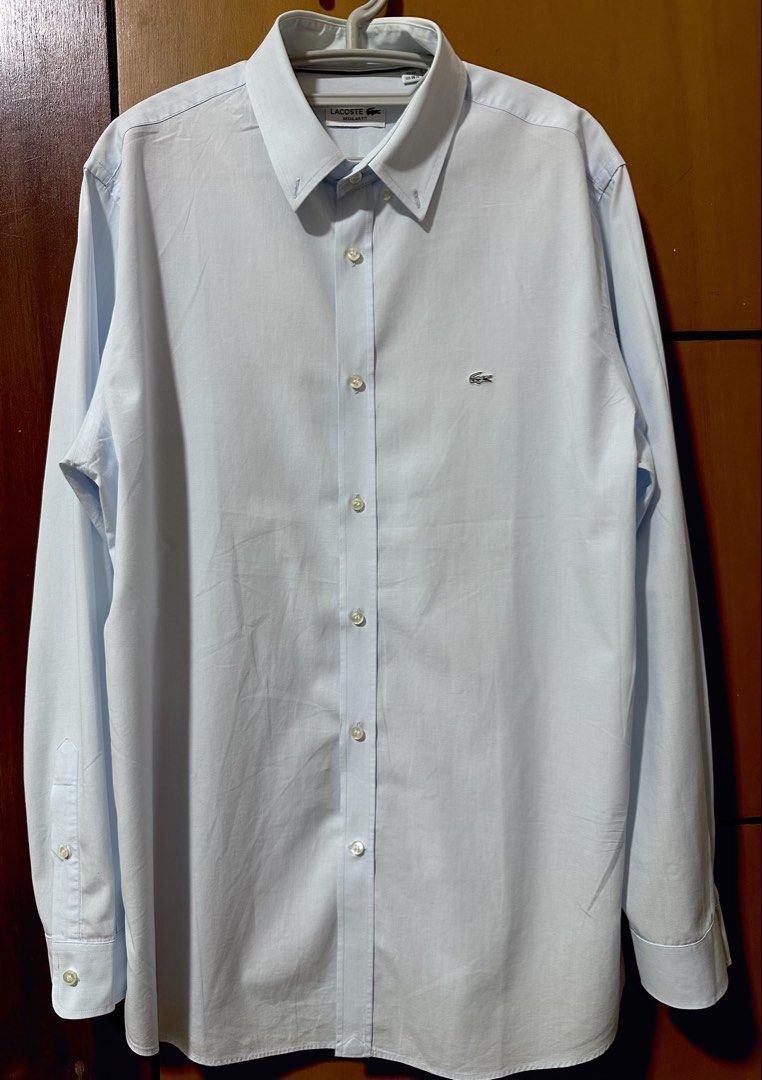 Lacoste Regular Fit Light Blue Long Sleeve Button-Down Shirt (Category: Formal Shirts) located in Quezon City. Submitted by aussomefinds (Listing ID 1465361565, Image 1). Description: - Brand: Lacoste - Style: Long sleeve button-down shirt with classic collar - Fit: Regular fit - Color: Light blue - Size: FR 42 / US 16.5 - Details: Iconic embroidered crocodile logo on chest, standard button cuffs - Ideal for: Smart casual wear, business meetings,