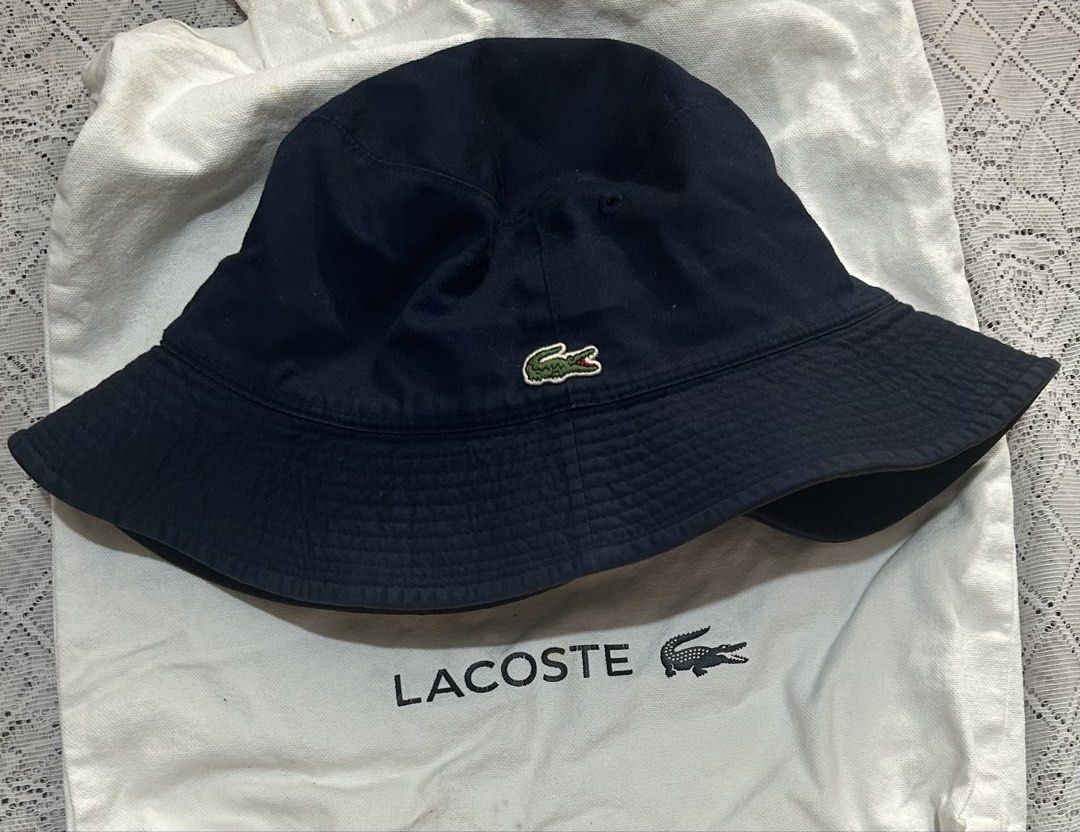 Lacoste Reversible Bucket Hat Navy Blue and Black (Category: Caps & Hats) located in Plaridel. Submitted by ilovebubu28 (Listing ID 1465173067, Image 2). Description: - 100% Authentic Lacoste reversible bucket hat - Side 1: Solid navy blue with embroidered crocodile logo - Side 2: Black with contrasting beige band and embroidered crocodile logo - Perfect for sunny days, casual streetwear, and versatile styling Hat only.