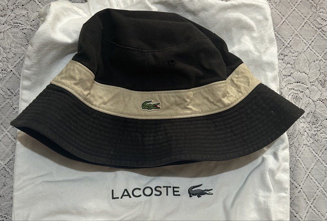 Lacoste Reversible Bucket Hat Navy Blue and Black (Category: Caps & Hats) located in Plaridel. Submitted by ilovebubu28 (Listing ID 1465173067, Image 3). Description: - 100% Authentic Lacoste reversible bucket hat - Side 1: Solid navy blue with embroidered crocodile logo - Side 2: Black with contrasting beige band and embroidered crocodile logo - Perfect for sunny days, casual streetwear, and versatile styling Hat only.
