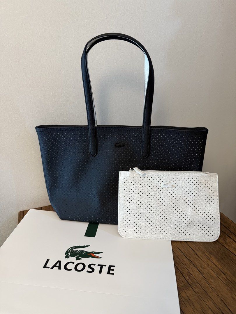 Lacoste Reversible Perforated Tote Bag with Pouch (Category: Tote Bags) located in Manila. Submitted by absndy (Listing ID 1465220162, Image 2). Description: - Authentic Lacoste reversible tote bag in classic black and white - Stylish perforated texture throughout with sturdy dual shoulder straps - Includes a matching detachable zip pouch for small essentials - Comes complete with the original Lacoste paper bag - Spacious, durable, and versatile 