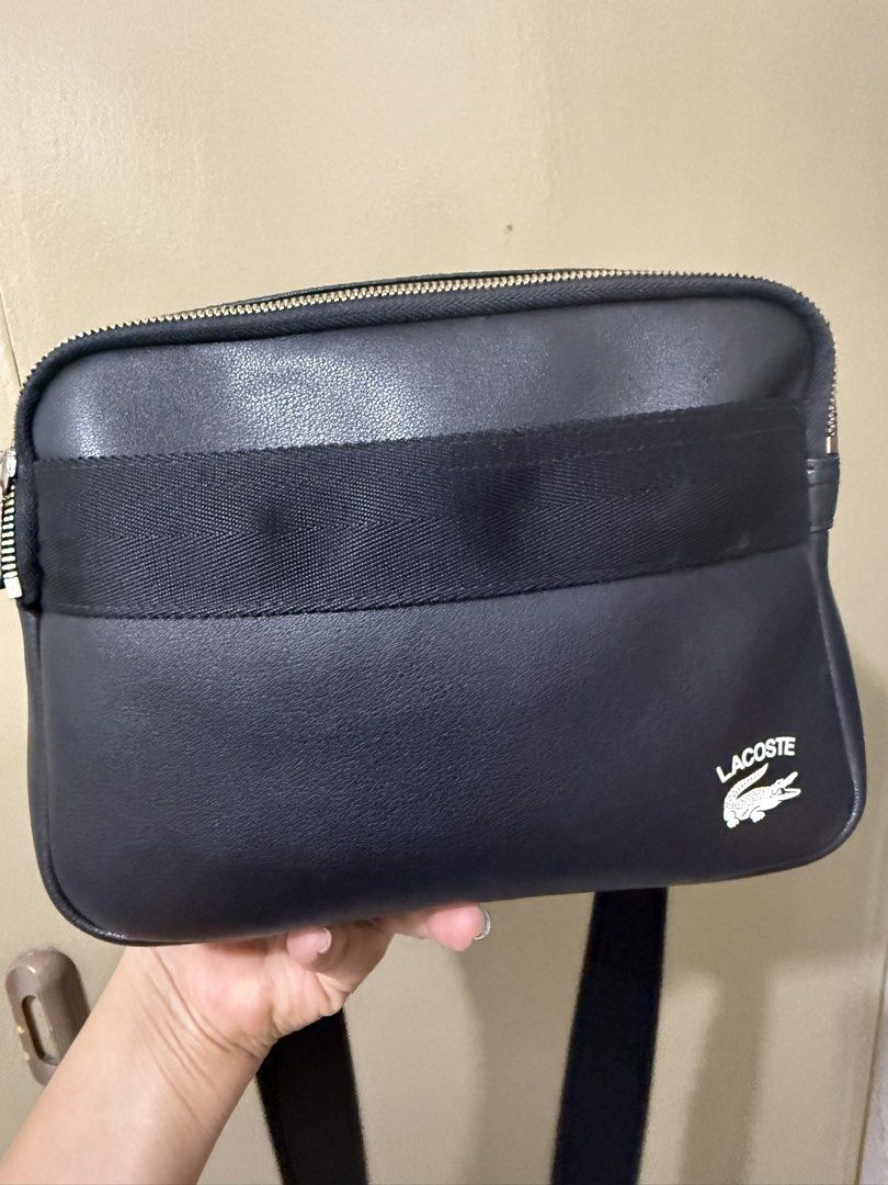 LACOSTE SLING BAG (Category: Cross-body Bags) located in Malabon City. Submitted by iamxtine29 (Listing ID 1465313067, Image 1). Description: good condition 10% ORIGINAL issue - Discoloration lang sa gilid ng ziper may bilog check nlang sa last photo.
