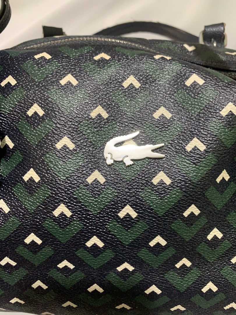 Lacoste Zely Monogram Duffle/Boston Bag (Category: Luxury Bags & Wallets) located in San Jose. Submitted by theluxed (Listing ID 1465199019, Image 2). Description: Width 14 Length 10 Good condition Has a minimal signed of usage No crack on the leather .
