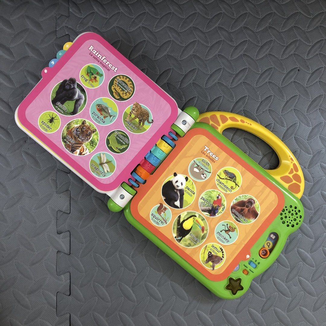 LeapFrog 100 Animals Book (Category: Educational & Learning Toys) located in Balanga. Submitted by lebabyvoyage (Listing ID 1465246908, Image 2). Description: - LeapFrog interactive learning book for toddlers - Bilingual modes in English and Spanish - Teaches animals, rainforest, trees, mealtime, and clothes - Colorful plastic pages with pictures and words - Built-in sound buttons for engaging play - Convenient yellow carrying handle - Battery-op