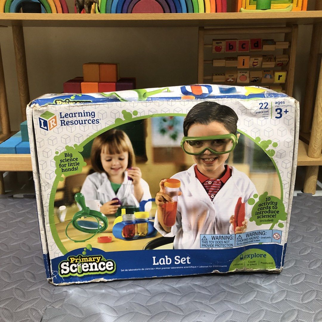Learning Resources Lab Set (Category: Educational & Learning Toys) located in Balanga. Submitted by lebabyvoyage (Listing ID 1465245433, Image 2). Description: - Brand: Learning Resources Primary Science Lab Set - Recommended Age: 3 years and up - Complete 22-piece set: test tubes, flask, funnel, magnifying glass, safety glasses, dropper, tongs, stands, and activity cards - Condition: Original box shows minor wear, but contents inside are complet