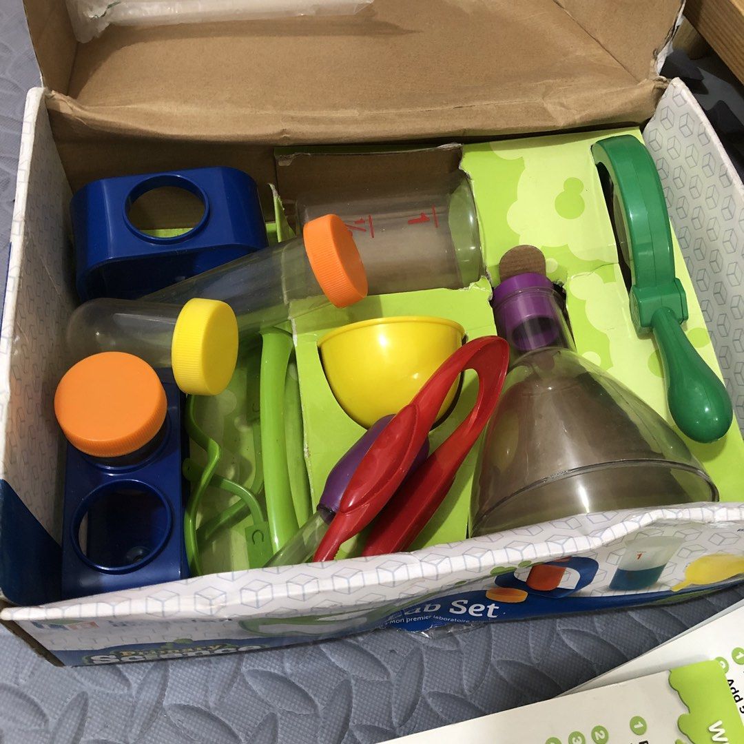 Learning Resources Lab Set (Category: Educational & Learning Toys) located in Balanga. Submitted by lebabyvoyage (Listing ID 1465245433, Image 3). Description: - Brand: Learning Resources Primary Science Lab Set - Recommended Age: 3 years and up - Complete 22-piece set: test tubes, flask, funnel, magnifying glass, safety glasses, dropper, tongs, stands, and activity cards - Condition: Original box shows minor wear, but contents inside are complet