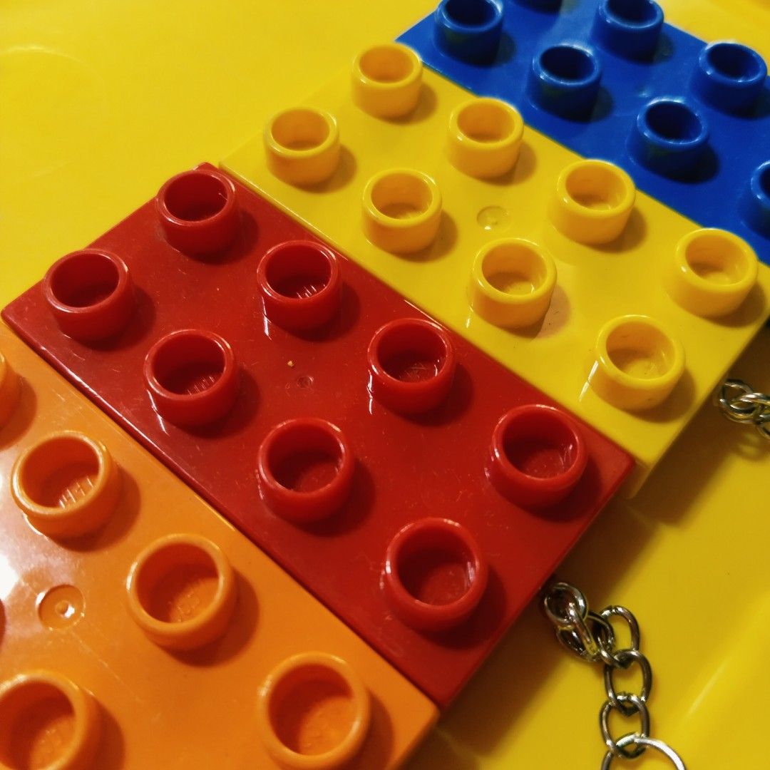 Original LEGO Duplo Modeled Keychains (Category: Lego & Building Sets) located in Pasig City. Submitted by babylove2003 (Listing ID 1465207280, Image 3). Description: Original LEGO with markings. LEGO Duplo markings keychains in blue, black, red, orange, yellow, green, lime green, and bright yellow. Each keychain is made from standard 2x4 LEGO bricks with an attached metal chain and ring. Great for keys or backpack charms. Sold individually or me