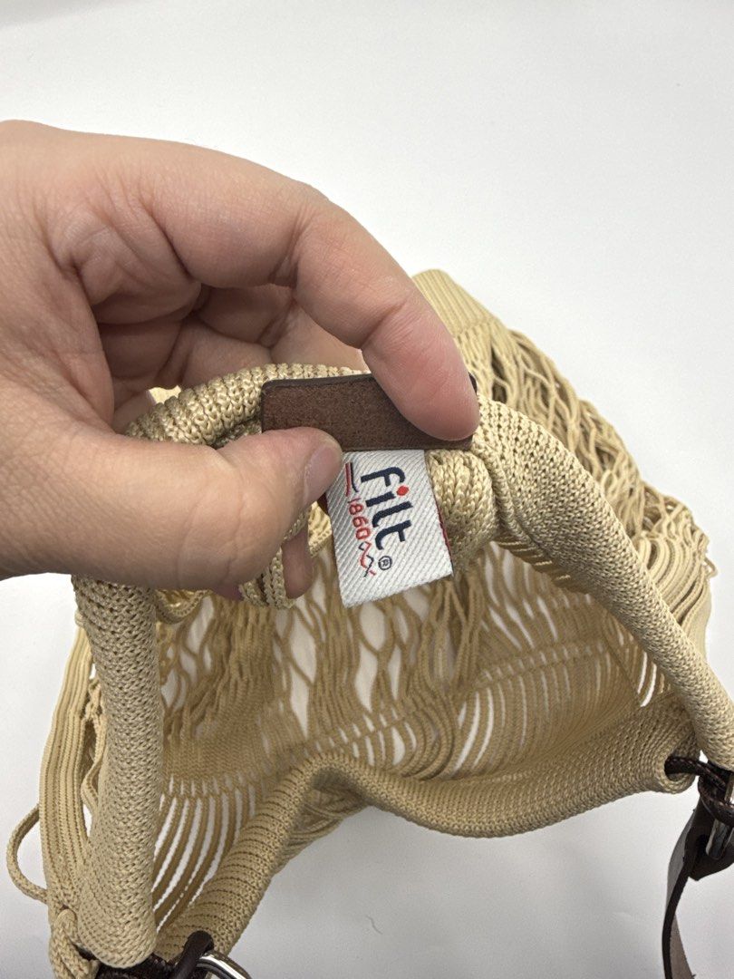 Lemaire (Category: Cross-body Bags) located in Caloocan City. Submitted by rossvault2 (Listing ID 1465228170, Image 3). Description: - Brand: Lemaire x Filt Collaboration - Color: Beige body with brown cow leather strap - Material: 100% cotton knit mesh with leather trim - Details: Embossed leather branding tab and interior tags (Model: BG0027 LL0028) - Origin: Made in Tunisia - Care: Professional leather clean only.